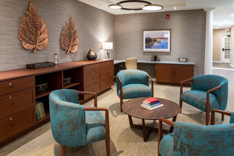 A cozy waiting room with modern furniture and decorative elements.