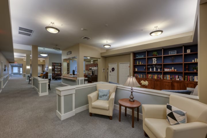 A cozy lounge area with comfortable seating and bookshelves.