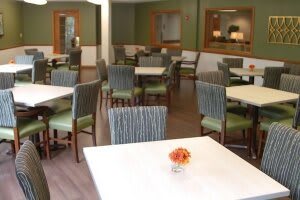 A modern and neatly arranged dining area with several tables and chairs.