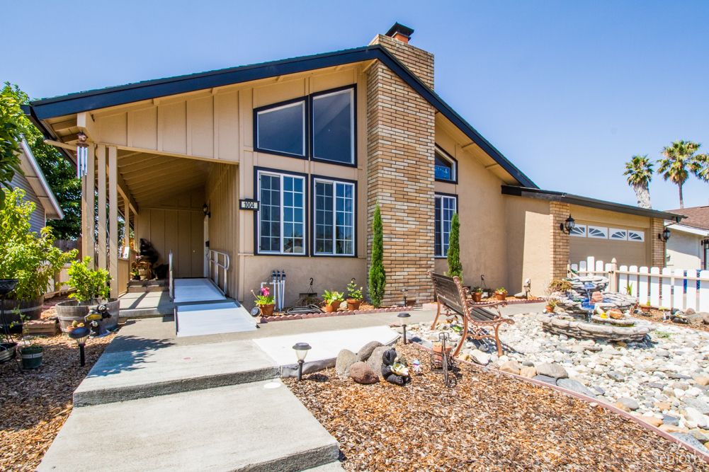 A modern residential home with a landscaped front yard.