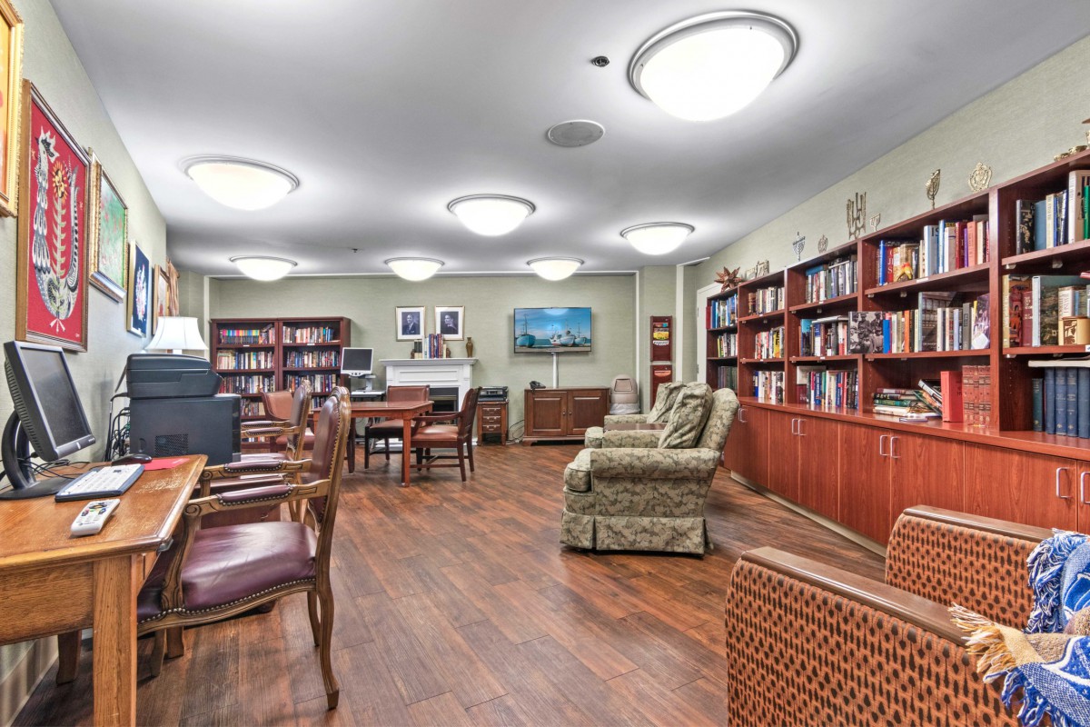 A cozy library space with bookshelves and comfortable seating.