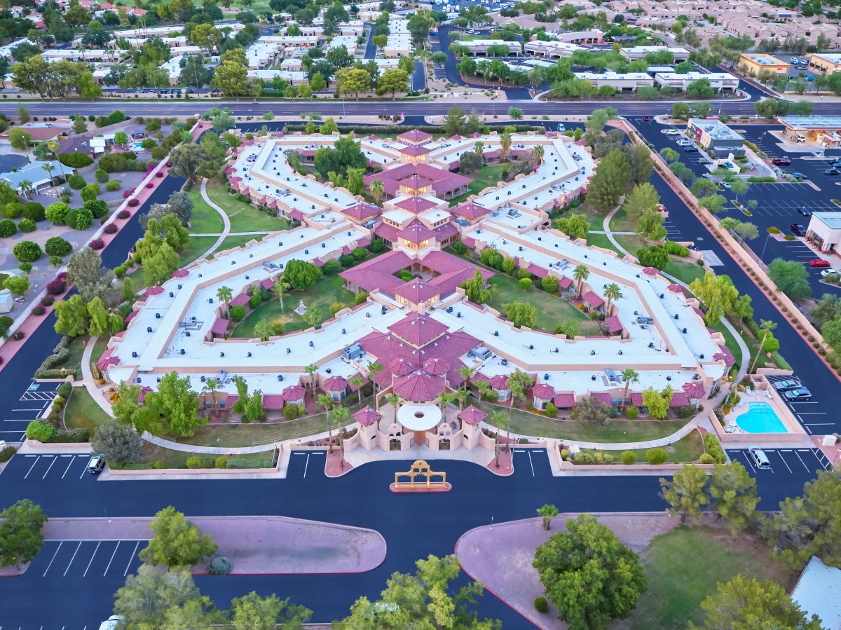 Aerial view of a beautifully designed park with intricate pathways and lush greenery.