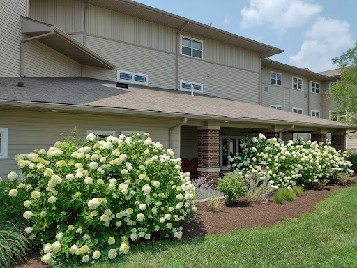 A beautifully landscaped residential building surrounded by blooming hydrangeas.