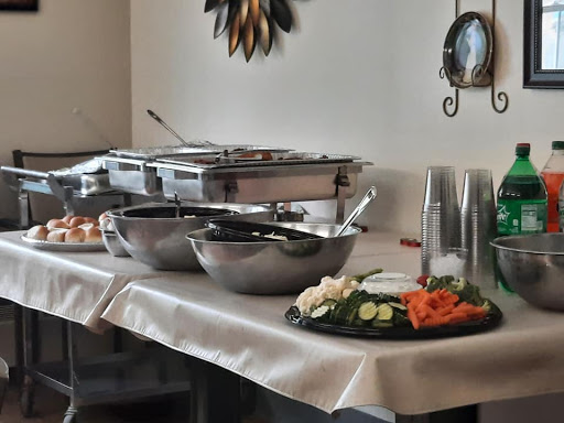 A beautifully arranged buffet setup featuring various salads and serving dishes.