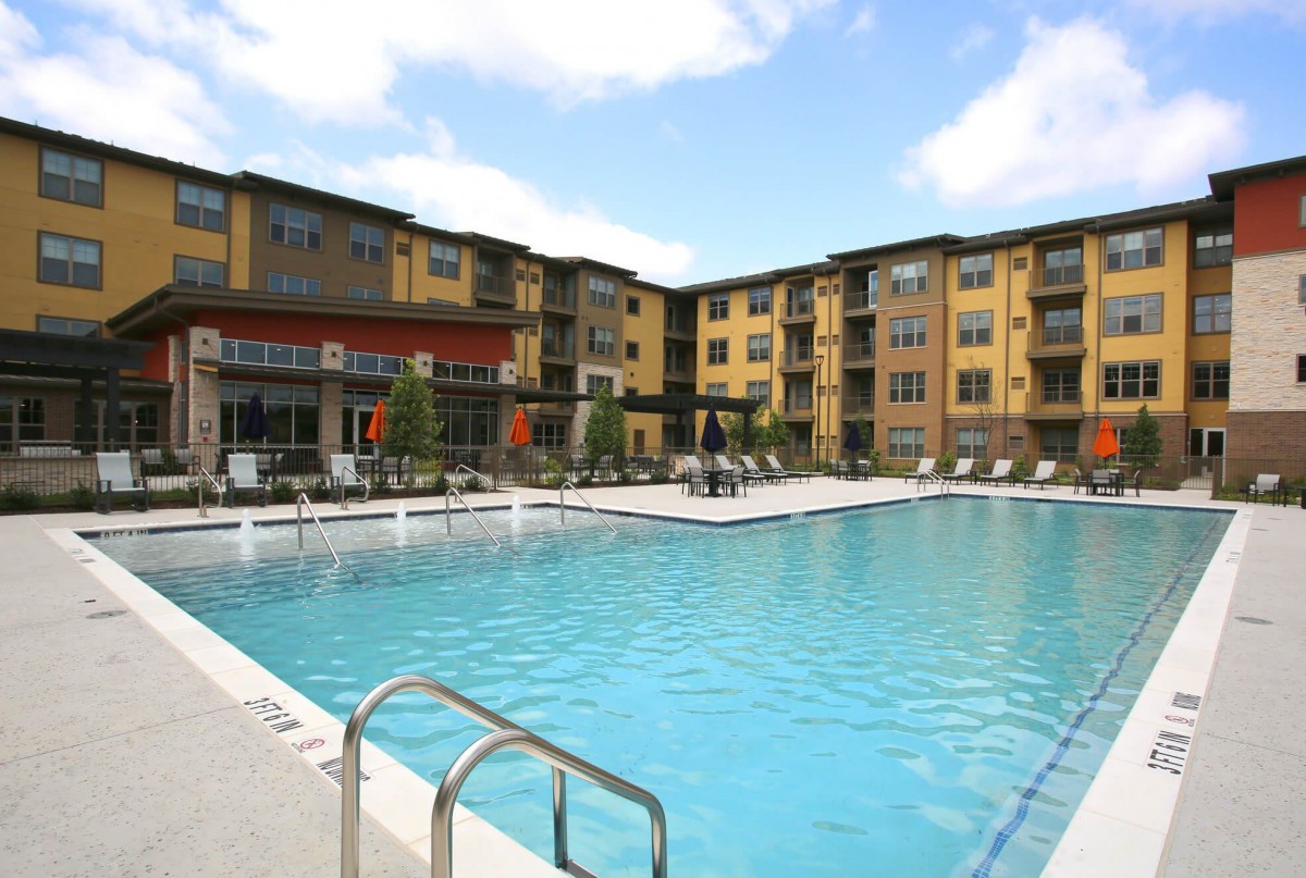 An outdoor swimming pool in a residential apartment complex.