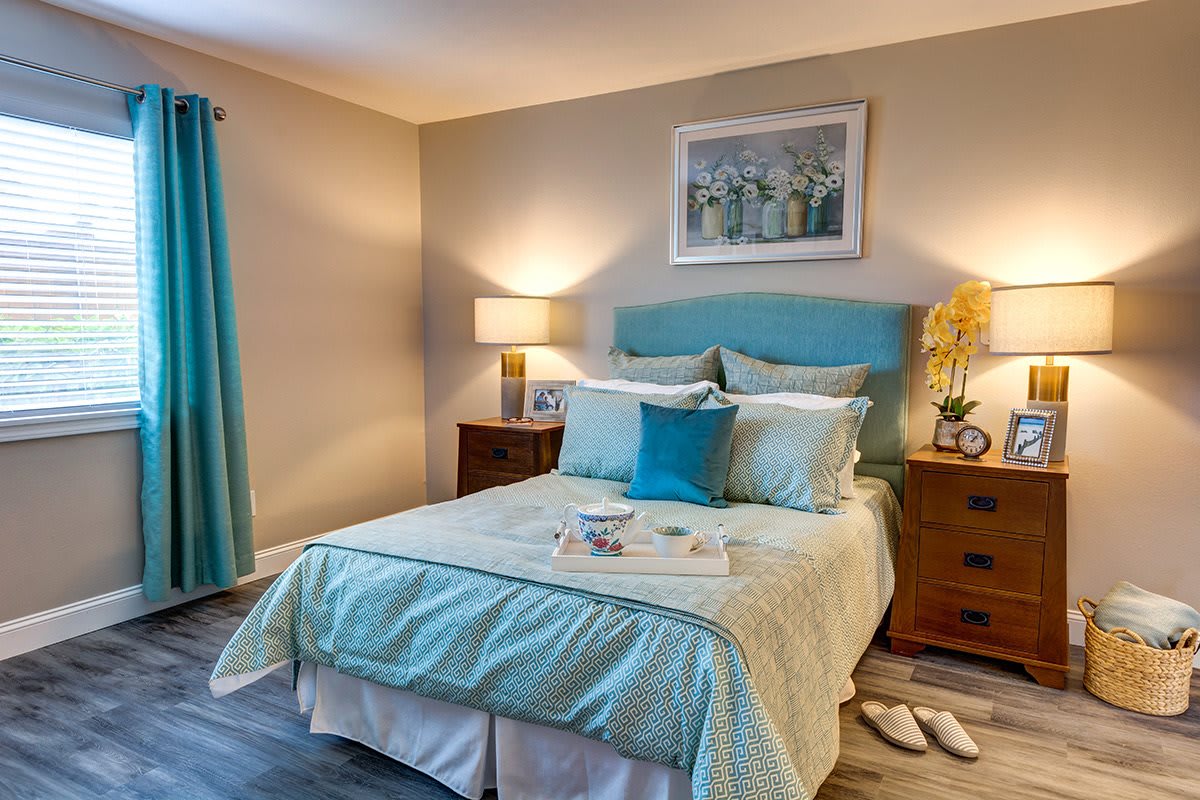 A cozy bedroom with teal accents and soft lighting.