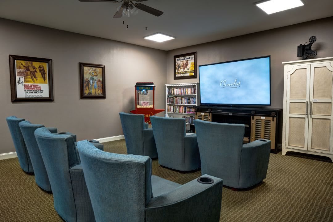 A cozy home theater setup with comfortable seating and a large screen for entertainment.