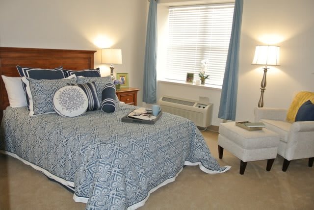 A cozy bedroom with blue-themed decor and soft lighting.
