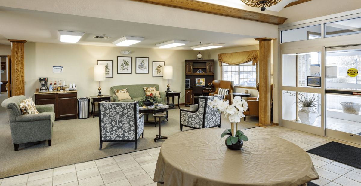 A cozy living room with elegant furniture and a home office area.