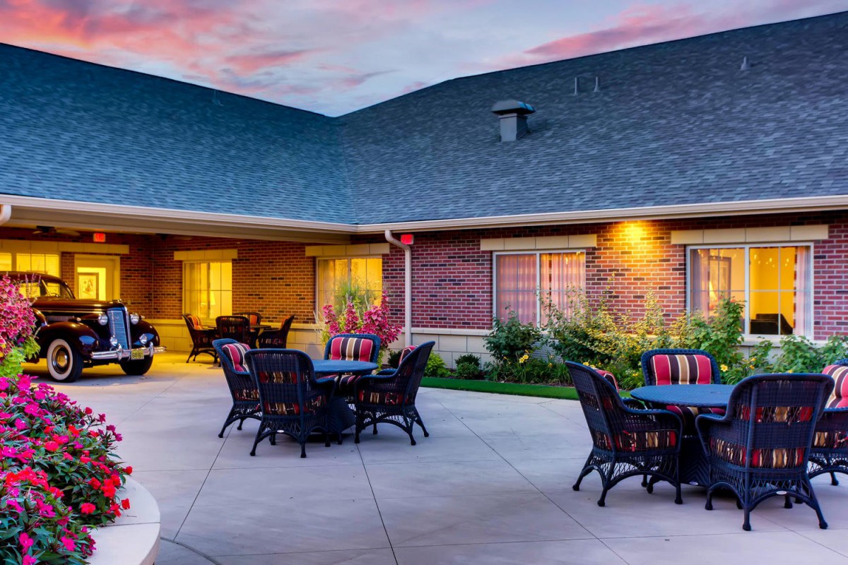 A cozy courtyard with outdoor seating at sunset.