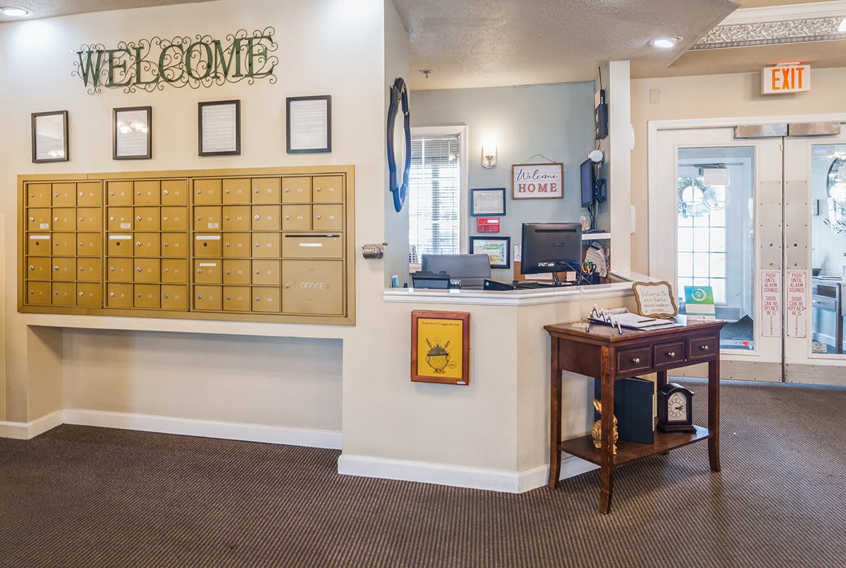 A welcoming reception area with a desk and mailboxes.