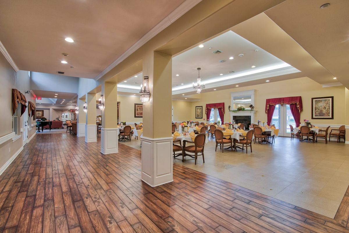 Spacious dining area with elegant lighting and wooden floors.