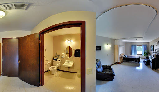 A view of a bathroom with modern amenities and adjoining living space.