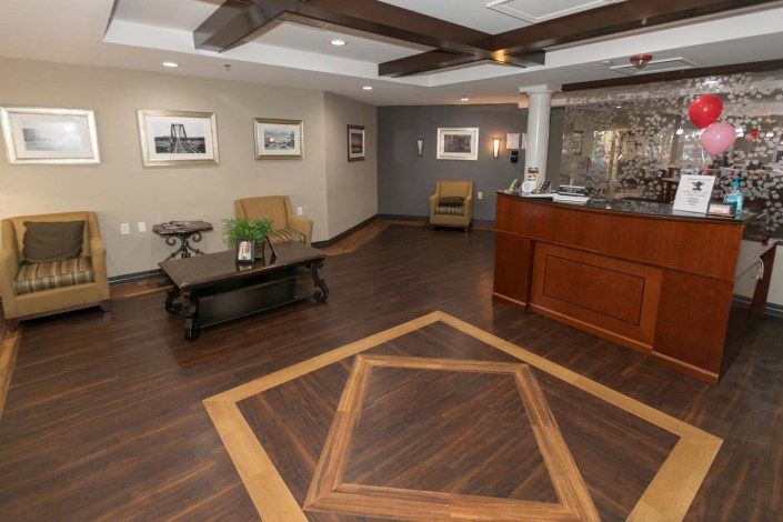 A stylish lobby with hardwood flooring, comfortable seating, and art on the walls.