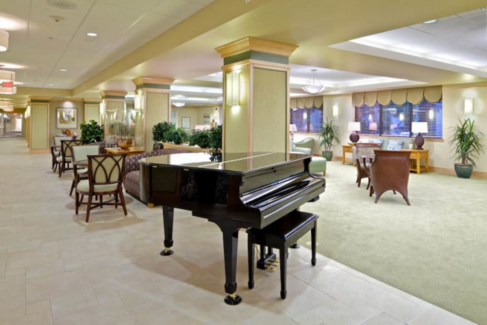 A luxurious lobby featuring a grand piano and elegant seating areas.