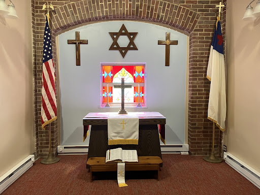 A multi-faith altar featuring Christian crosses and a Star of David, symbolizing interfaith dialogue.