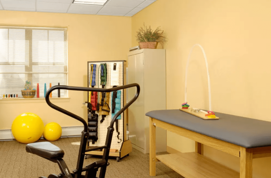 A physical therapy room equipped with exercise equipment and therapy tools.