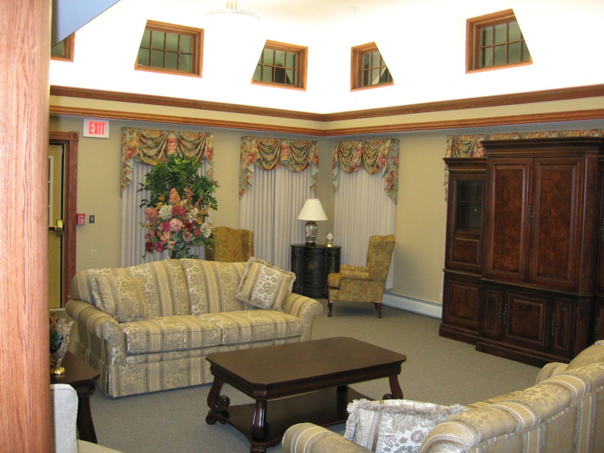 A traditional living room with sofas, a coffee table, and decorative elements.
