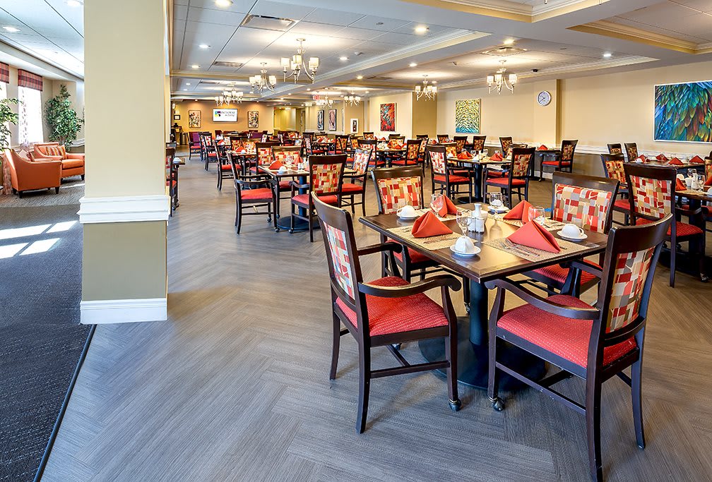 A well-decorated dining room with neatly arranged tables and chairs.