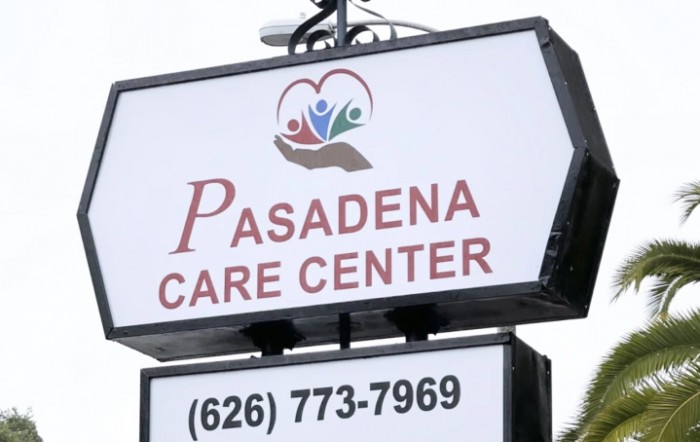 Sign for Pasadena Care Center with contact number displayed.