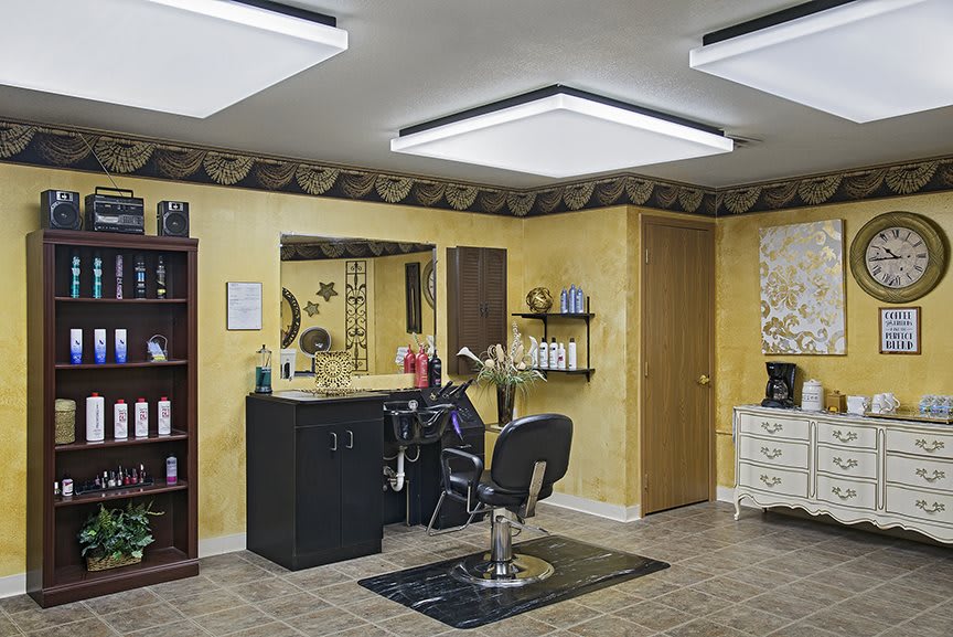 An interior view of a hair salon with a barber chair and various hair products.