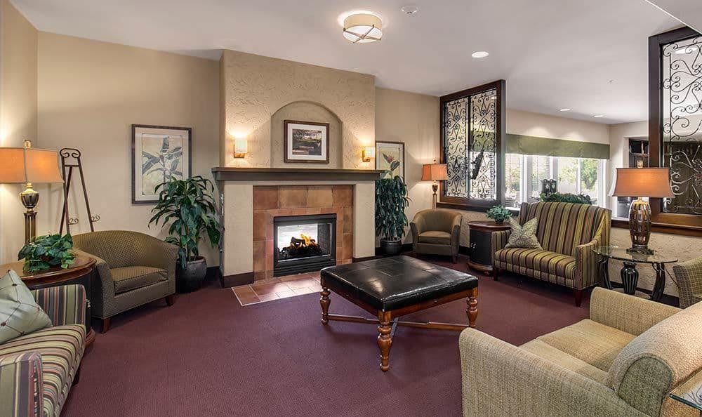 A cozy living room with a fireplace and comfortable seating arrangements.