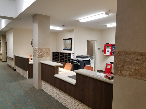 A view of a reception area in an office, featuring a counter and seating.