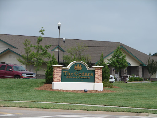 Entrance sign of a residential community featuring well-maintained landscaping.