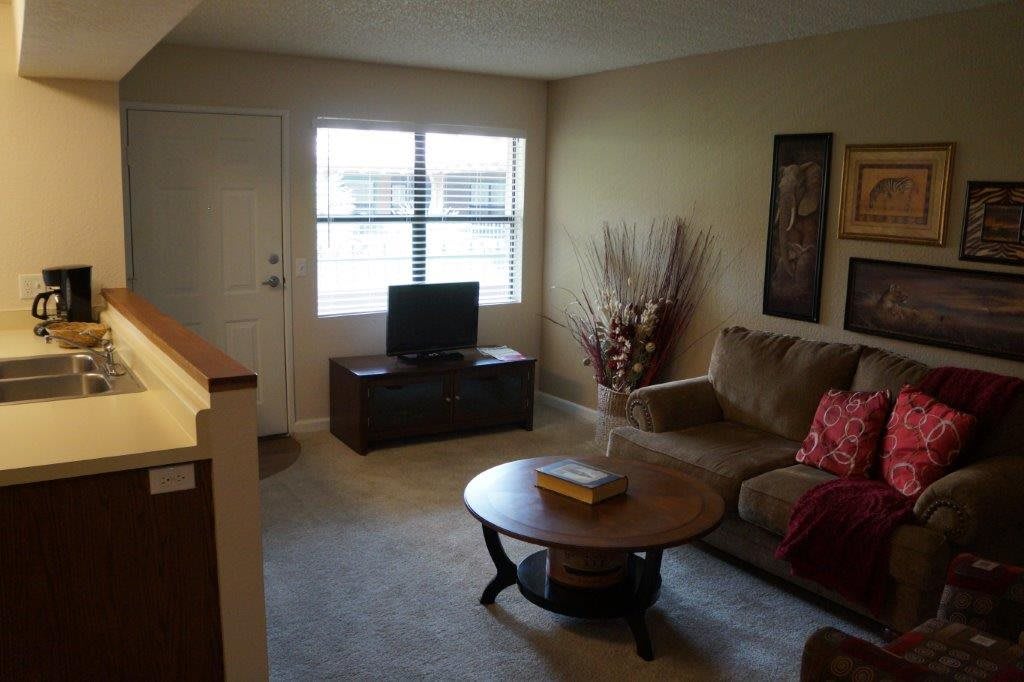 Cozy living room with a sofa, television, and coffee table.