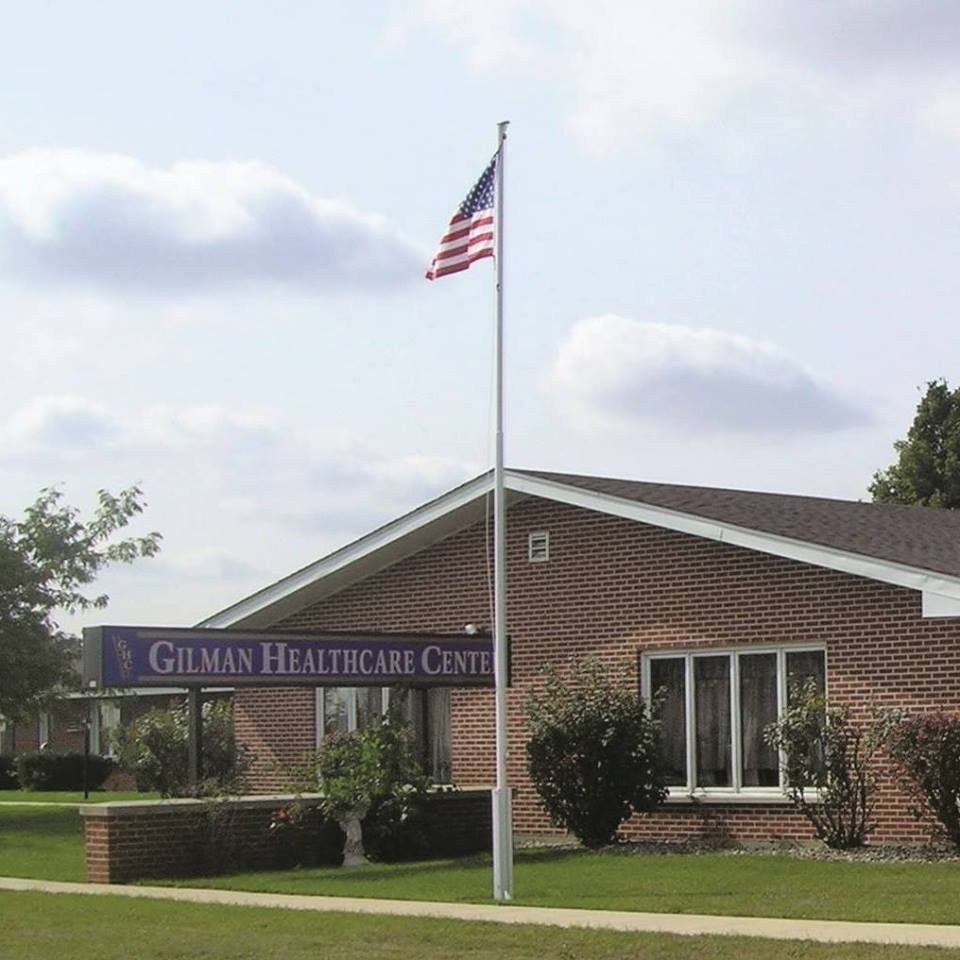 A brick church with an American flag flying on a flagpole.