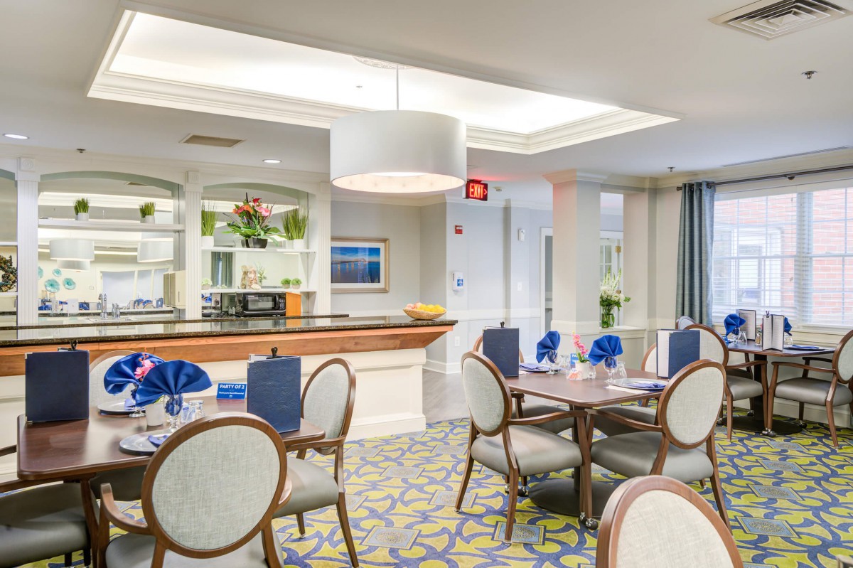 A modern dining area with elegant furnishings and warm lighting.