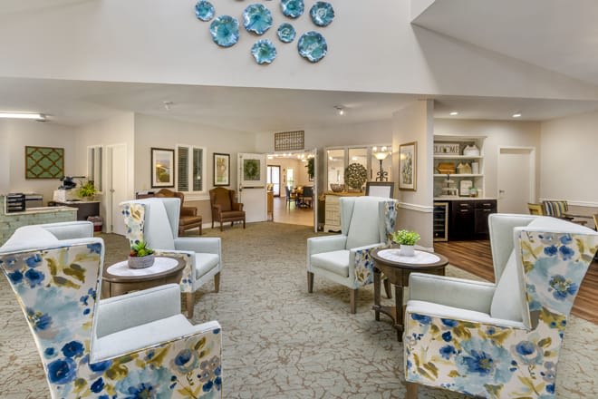 A modern lounge area featuring comfortable seating and decorative wall art.