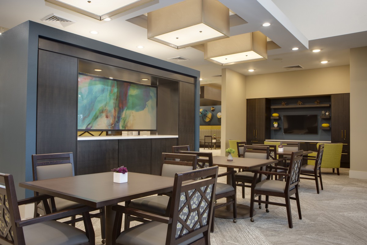 A modern dining space with neatly arranged tables and chairs.