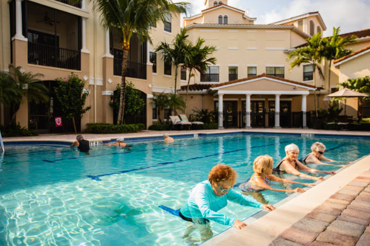 Seniors participating in aquatic exercises at a community swimming pool.