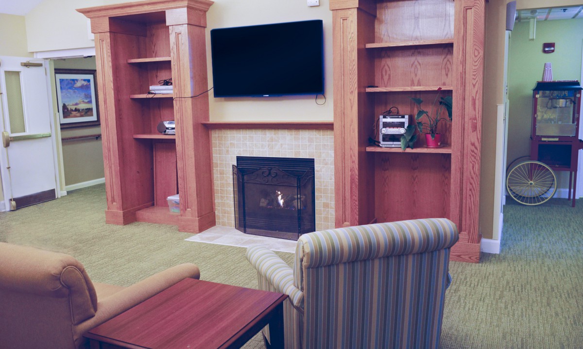 Cozy living room with a fireplace and mounted television.