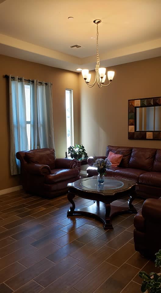 A cozy living room with leather seating and elegant decor.