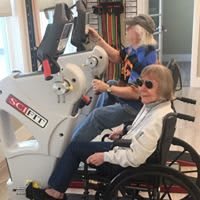 Seniors engaging in exercise with specialized equipment.