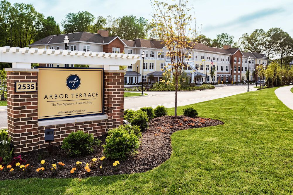A well-maintained residential complex with landscaped grounds and a prominent entrance sign.