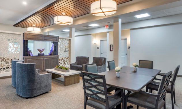 A modern lounge with comfortable seating and a meeting table.