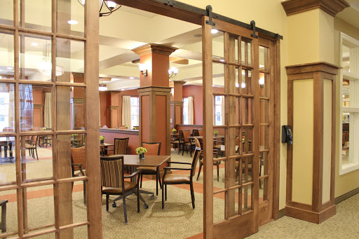A cozy dining area featuring wooden sliding doors and ample seating.