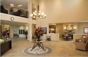 A modern lobby with a chandelier and stylish decor.
