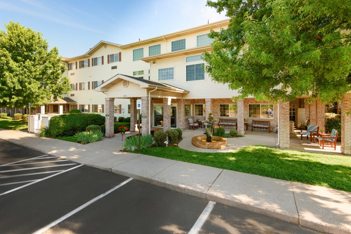 A well-maintained apartment building with a welcoming porch and landscaped surroundings.