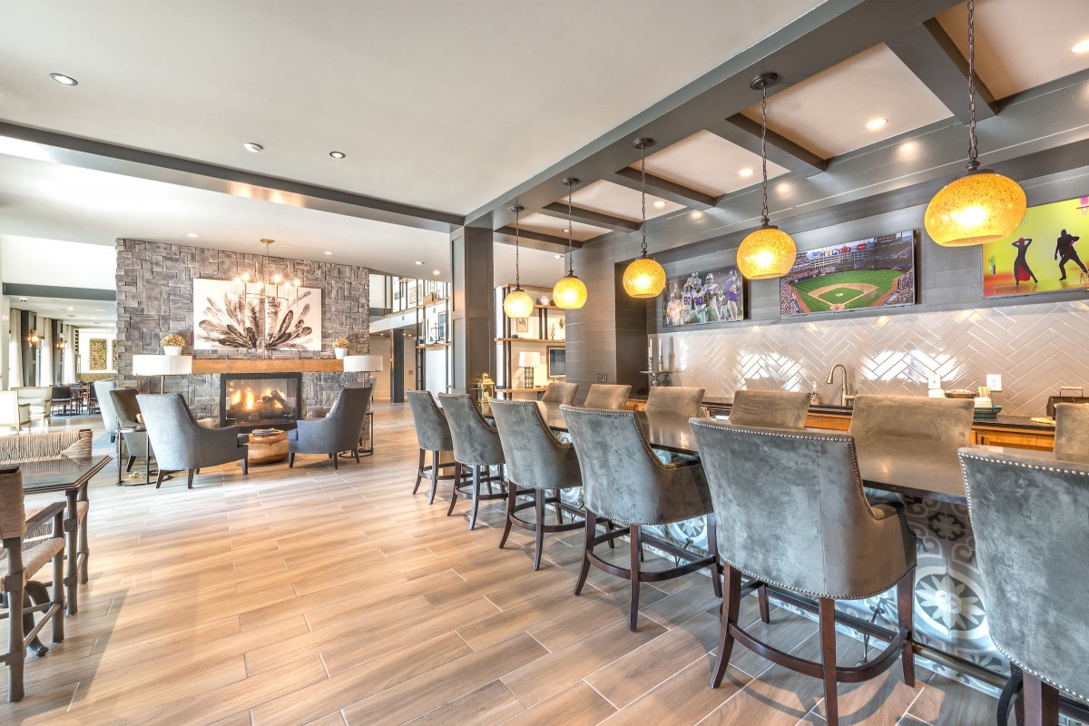 A modern bar interior with elegant seating and warm lighting.