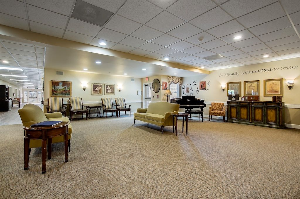 A spacious lobby with comfortable seating and a grand piano.