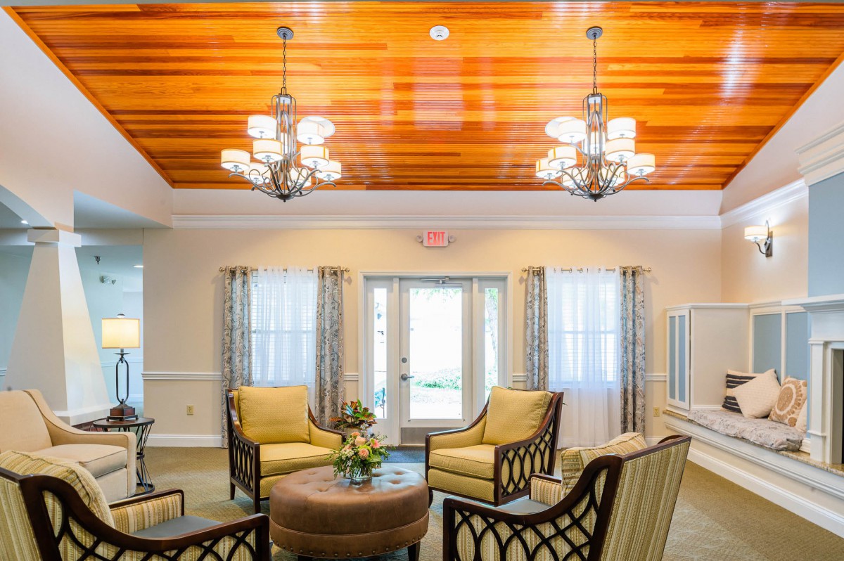 A cozy living room with elegant chandeliers and comfortable seating.