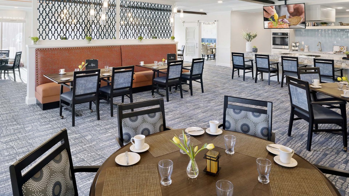 A cozy indoor dining area with neatly arranged tables and chairs.
