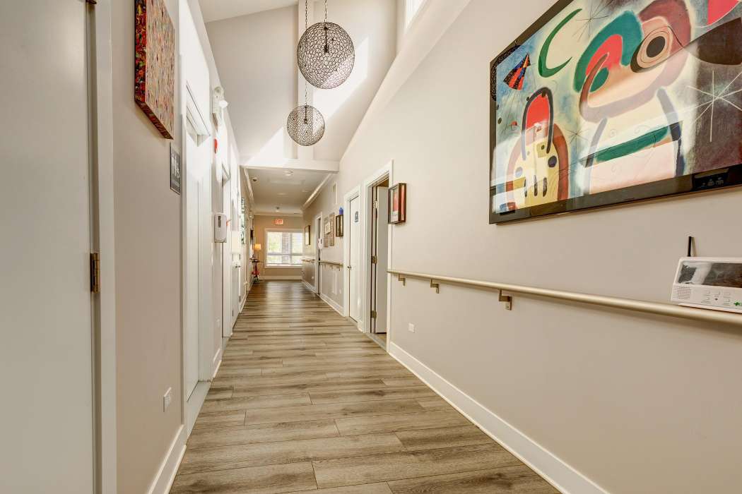 A modern hallway with artistic decor and stylish lighting.