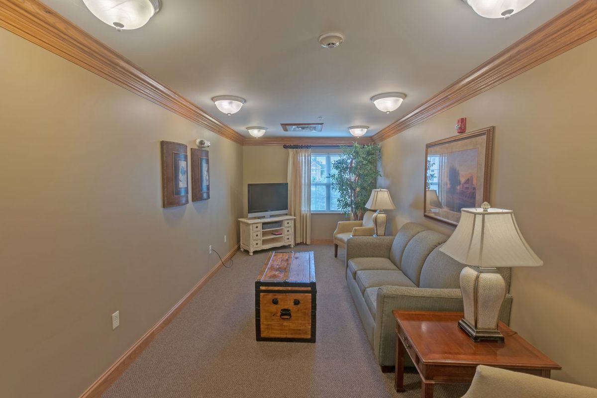 A cozy living room with a sofa, television, and soft lighting.