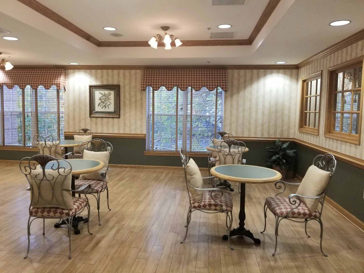 An inviting cafe interior with tables and chairs on a wooden floor.