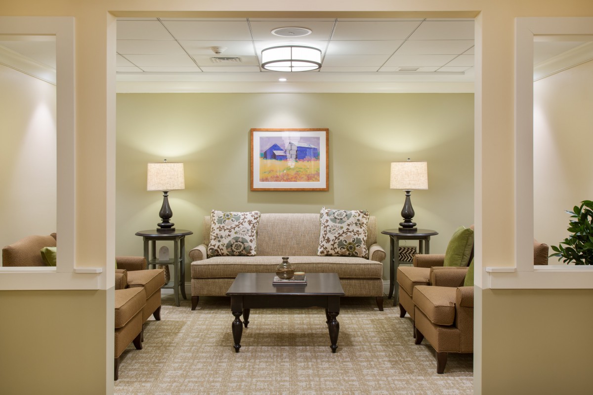 A well-furnished living room with comfortable seating and warm lighting.